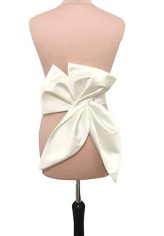 This big fashion bow is made from ivory Duchess satin and can be perfect choice for your glamour bridal look. The length of the bow is about 50cm. Our bow can be ordered separate or with belt. Can be made in soft matte satin, duchess satin or Mikado fabric. ALL OF OUR PRODUCTS ARE HANDMADE BY US AND MADE WITH THE BEST HIGH-QUALITY FABRICS. If you have any questions about our products do not hesitate to contact us! SAMPLES(SWATCHES) LOWER COST SHIPPING, FOR CUSTOMER FROM OUTSIDE THE UK PLEASE USE THIS LINK FOR SAMPLES(SWATCHES): https://www.etsy.com/uk/listing/949775560/fabrics-samples-swatches-glitter-tulle?ref=listings_manager_grid *DELIVERY We use standard delivery service for the UK with Royal Mail 1st class service which normally takes 1-2 working days without tracking. For internation Dress With Bow Belt, Bow Belt Dress, Chic Evening Bow With Detachable Feature, White Fitted Dress With Detachable Bow, Classic Detachable Bow, Luxury Satin Bow Tie Back Bow, White Detachable Bow For Evening, Chic Mini Wedding Dress With Detachable Bow, Wedding Dress Bow