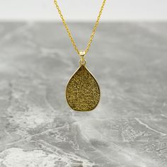 Crafted as a timeless piece of art, the Ayatul Kursi Islamic Necklace transcends mere adornment, embodying elegance and spirituality. This exquisite necklace features intricate Arabic calligraphy, delicately engraved to showcase the revered verses from the Quran. Made with 925 sterling silver and luxuriously gold plated, this pendant exudes a sense of divine beauty and grace. A perfect gift for the modern Muslim woman, this dainty necklace is a symbolic expression of faith and devotion. Whether Traditional Teardrop Necklace For Gift, Elegant Teardrop Pendant Necklace For Meditation, Elegant Engraved Necklace With Rectangular Pendant, Gold Teardrop Pendant Necklace As Gift, Elegant Teardrop Pendant Jewelry For Meditation, Elegant Teardrop Necklaces For Meditation, Spiritual Etched Rectangular Pendant Necklace, Etched Rectangular Pendant Spiritual Necklace, Symbolic Necklace With Large Pendant For Formal Occasions