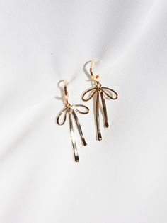 "★ Gold Bow Huggie Earrings ★ A pair of modern charm earrings featuring gold-plated bows in a bold 3-D design for a playful touch to your look.  Trend-forward gift for those with pierced ears. Product Features: * 1-3/4\" drop length x 3/4\" wide * Gold-plated ear wire * Gold-plated 3-D bow pendants * Nickel-free In support of small businesses, all jewelry-making supplies are purchased from fellow Etsy Sellers and small, independent shops. Head to my store for more!" Gen Z Jewelry, Twee Style, Bow Outfit, Aesthetic Bow, Trendy Girl, Style Preppy, Bow Earrings, Gen Z, Jewelry Earrings Hoops