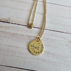 This hand stamped brass necklace will make a great gift for any woman in your life. Choose from 4 different sayings, for the perfect gift for anyone! Choose your saying from the drop down menu on the listing.The brass charm is approx 1" x 3/4" and is attached to an 18" gold plated stainless steel chain. The charm has a lightly brushed finish, hammered edges, and is hand stamped to order, using the quote that you selected. The stamped impression is then filled in with a long lasting black ink.If Necklace Trendy, Handmade Brass, Brass Charms, Brass Necklace, Just Breathe, Brass Jewelry, Drop Necklace, Trendy Jewelry, Steel Chain