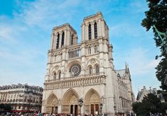 people are standing in front of a large cathedral