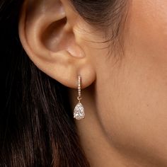 Simply elegant, and absolutely gorgeous. Welcome these timeless diamond dangle earrings into your life! We make our pear cut diamond drop, diamond huggie hoop earrings in your choice of 18k gold (rose, yellow, or black, or white upon request). Here, in 18k rose gold. 18k rose gold pear cut diamond drop earring on diamond-faced hinged huggie hoops. 2.12cts (pair) of white diamonds. F color, VS1 clarity 18k rose gold hardware. Diamond-faced hinged huggie hoop earwires with hidden closure. Lovingly Luxury Formal Huggie Earrings, Luxury Teardrop Diamond Earrings With Brilliant Cut, Luxury Diamond Cut Drop Huggie Earrings, Luxury Dazzling Huggie Earrings With Diamond Accents, Luxury Dangle Huggie Earrings With Prong Setting, Luxury Diamond Drop Earrings With Pave Setting, Elegant Luxury Huggie Earrings With Prong Setting, Luxury Dainty Huggie Earrings With Diamond Accents, Timeless Luxury Huggie Earrings For Anniversary