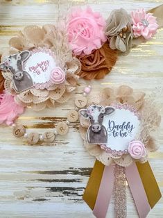 three baby girl hair clips with pink flowers and deer on them, one has a name tag that says daddy to be