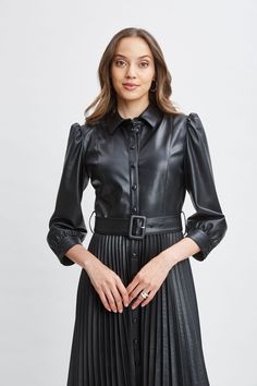 Meet our modern, endlessly versatile Vegan Leather Shirtdress that's infused with an edgy feminine vibe. The sporty shirt-dress silhouette, self-belt & pleated midi skirt give it the cool factor you want for easy Fall days. Dress it up with heels or down with sneakers- effortlessly chic either way. T-Tahari Vegan Leather Long Sleeve Belted Pleated Midi Dress 100% Polyurethane Runs true to Size Model is 5'9" and wearing size S Dry Clean Only Imported Style #: THF49028 Sporty Shirt, Edgy Feminine, Fall Days, Easy Fall, Long Sleeve Short Dress, Office Dresses, Pleated Midi Dress, Dress Silhouette, Pleated Midi Skirt