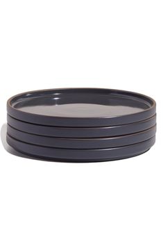 four black plates stacked on top of each other