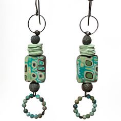 Modern Tribal Earrings / Chocolate Mint Series with artisan polymer beads and charms, African turquoise, and embedded soldered structure  Weight: 3.6 grams / .13 ounces (very light!) I made all of the polymer components in these earrings. Gorgeous mokume gane rectangles are the focals, with minty bead discs  ( 10 of them stacked at the top), and custom colored rounds. The soldered ring of beads at the bottom are micro-faceted African turquoise. Absolutely love how these came out! The solder used is jewelry grade, silver bearing, and lead-free.  The ear wires are niobium. Thank you for looking! To get back to my shop: WitherWare.Etsy.com Although this shop is new, I've been selling my art on Etsy for almost 12 years. My art shop is here: ElizabethRosenArt.Etsy.com Polymer Beads, Chocolate Mint, Polymer Earrings, Mokume Gane, Sell My Art, Earrings Colorful, African Turquoise, Turquoise Earrings, Ear Wires