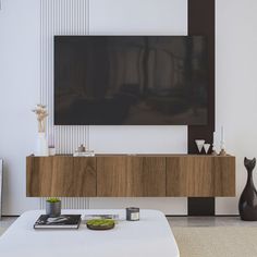 a large flat screen tv mounted to the side of a wall in a living room