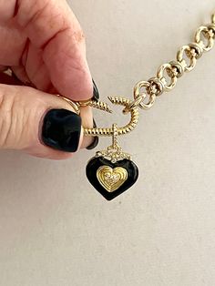 This shiny gold-plated cable chain necklace has a great weight to it. It connects to a gold rope design spring lock carabiner. The pendant is made of black enamel, pave stones, and a double heart in gold. The bale on the pendant is also encrusted in pave. This is a show-stopping necklace of modern and trendy design. The chain is lead-safe and nickel free. The chain's large link is 1/2 in and the middle link is 1/4 in. The Carabiner and chain is brass with 14k gold plating. The length of the neck Gold Charms For Necklace, Carabiner Necklace, Kids Picnic, Necklace Packaging, Necklace Charms, Cable Chain Necklace, Necklace Clasps, Heart Pendant Gold, Funky Jewelry