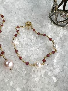 Buy individually or as a set & save!Choose from beautifully faceted Garnet rosary style chain, accented with lustrous Freshwater Pearls. Gorgeous classics with a bit of flair & color!Necklace: Rosary style faceted Garnets are accented with a lustrous 9 X 10mm Freshwater Pearl, which is hand wired to the center of the necklace. The Pearl pendant can be removed if you choose to wear them separately or the pendant on a different chain.Length: 16" with 2" extenderBracelet: Faceted Garnets are wire w Elegant Faceted Beads Jewelry Bracelet, Gold Crystal Bracelet With Beaded Chain For Gift, Elegant Wire Wrapped Beaded Bracelets For Party, Elegant Wire-wrapped Beaded Bracelets For Party, Faceted Beads Rosary Bracelet For Gift, Elegant Party Beaded Bracelets Wire Wrapped, Elegant Rose Gold Jewelry With Faceted Beads, Elegant Gold Crystal Bracelet With Beaded Chain, Wire Wrapped Briolette Jewelry For Party