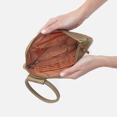 two hands holding an open purse on a white background