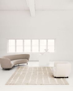 a living room with white walls and furniture