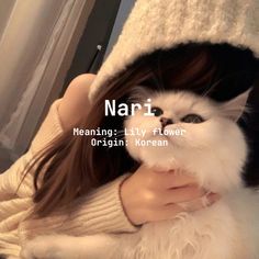 a woman holding a white and black cat in her arms with the caption nari meaning kitty flower origin korean korean