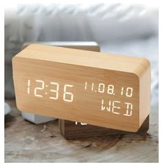 an alarm clock sitting on top of a wooden table