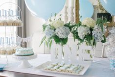 a table topped with blue and white desserts