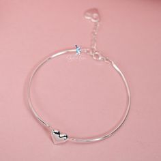 This beautifully crafted bracelet showcases two linked bangle pieces, complete with an adjustable chain and a charming heart-shaped charm. Made of high-quality 925 sterling silver, it makes for an exceptional Valentine's gift for your special someone. Treat your loved one to a piece of jewelry that is as stunning as it is meaningful. The Solid silver Valentine heart half bangle bracelet is a symbol of your love, beautifully crafted from 925 sterling silver and complete with an adjustable chain f Heart Shape Bracelet, Heart Bangle Bracelet, Chain Heart, For Your Love, Valentine's Gift, Valentine Gift, Bracelet Silver, Valentine Heart, Jewelry Plate