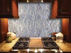 a stove top oven sitting inside of a kitchen next to wooden cupboards and counter tops