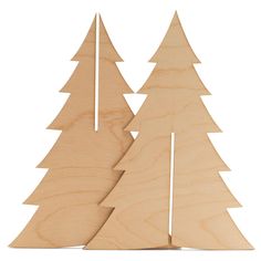 two wooden christmas trees are shown against a white background and one is cut out from the wood