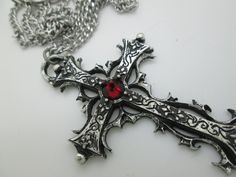 This Gothic cross necklace is an handmade pewter sculpture orned with an Austrian Swarovski or a real gem (My fav is the Black star Diopside, seriously) This gothic necklace is sold with a stainless steel chain of 18'' or 24'', if you would like to have a different length for the chain, you can write the desired length in the private note section when ordering :) This is a Gothic cross of 7cm This gothic cross necklace is a pewter sculpture of my own creation, i create and work the metal by myse Gothic Cross Pendant Jewelry For Halloween, Cross-shaped Halloween Jewelry Gift, Gothic Metal Cross Pendant Jewelry, Gothic Cross Pendant Jewelry, Gothic Cross Jewelry As Gift, Gothic Cross Jewelry Gift, Gothic Cross Jewelry For Gifts, Silver Cross Jewelry For Halloween, Halloween Gift Cross Pendant Necklace