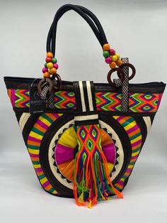 These beautiful handbags are made from Cana Flecha which is an indigenous palm fiber found in the northern territory of Colombia. They are beautifully hand crafted by the people from the Zenu tribes in Colombia. These handbags are colorful with vibrant colors, which is a pure reflection on the region and the warmness of these master artisans that work in this industry every day. Bohemian Multicolor Double Handle Beach Bag, Traditional Tote Beach Bag For Travel, Multicolor Bohemian Straw Bag With Double Handle, Traditional Top Handle Straw Bag, Traditional Tote Bag For Vacation, Traditional Top Handle Bag In Natural Color, Traditional Top Handle Shoulder Bag In Natural Color, Bohemian Handwoven Crochet Bag With Double Handle, Bohemian Crochet Bag With Double Handle