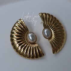 Vintage 14k Gold Plated Faux Pearl Statement Pierced Art Deco Style Fan Earrings, Fan Pearl Earrings, Fan Shape Pearl Stud Earrings Welcome!  Our jewelry is crafted with precision and made from high-quality materials. Here are the features of our products: ✨Material: Stainless Steel and Brass ✨Handmade Jewelry: Each piece is meticulously crafted by hand. ✨Anti-Allergic and Skin-Friendly: Suitable for sensitive skin. ✨Waterproof: Suitable for daily use and resistant to water exposure. ✨Tarnish Resistant: Designed for long-lasting wear and resistance to tarnishing. ✨Free Shipping: Enjoy free shipping on all our products. ✨High-Quality Materials: We use high-quality steel and brass in our production. ✨Gift Packaging: Each product comes in a special gift package. ✨Fast Shipping: Ready to be sh Fan Earrings, Pearl Stud Earrings, Pearl Studs, Art Deco Style, Style Art, Deco Style, Art Deco Fashion, Faux Pearl, Jewelry Earrings Dangle