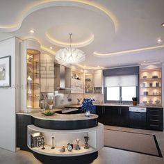 an elegant kitchen with white walls and black counter tops, lighted by recessed lights