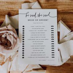 a wedding ceremony program with a flower on the table next to it and some pieces of paper