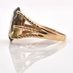 Exquisite 14 karat solid yellow gold ring set to the front with one large oval-cut smoky quartz measuring approximately 18 millimeters long by 13 millimeters wide and weighing an estimated 10.56 carats. The ring is a size 6 1/2 and can be re-sized to fit by your local jeweler. It is stamped 14K and signed AJ. It weighs approximately 6.23 grams. Excellent estate condition. We are listing several pieces of estate jewelry, along with other items fresh from fine North Carolina estates. We are happy Gold Oval Faceted Ring, Oval Gold Faceted Rings, Heirloom Oval Faceted Ring, Gold Oval Ring With Diamond Cut, Oval Gold Ring With Diamond Cut, Vintage Gold Faceted Rings, Gold Marquise Cut Collectible Jewelry, Collectible Marquise Cut Gold Jewelry, Oval Diamond Cut Rings For Collectors