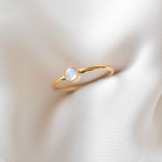 A simple gold ring featuring a genuine moonstone (4mm in diameter). The natural blue flash of the moonstone is visible depending on the light and angle. This ring is 14k gold filled and is hypoallergenic, water-resistant, and tarnish-resistant. --------------------♥ PROMOS ♥-------------------- Want 10% off? Join the mailing list by visiting http://bit.ly/vedern . --------------------♥ BUY WITH CONFIDENCE ♥-------------------- Don't love it? Message me to set up a return or exchange. If you find Gold Moonstone Stackable Jewelry, Gold Minimalist Moonstone Jewelry, Minimalist Adjustable Moonstone Ring As Gift, Minimalist Gemstone Round Band Jewelry, Minimalist Gemstone Jewelry With Round Band, Adjustable Minimalist Moonstone Ring As Gift, Gold Stackable Moonstone Ring, Round Shape, Minimalist Adjustable Moonstone Ring For Gift, Minimalist Opal Ring With Bezel Setting As Gift