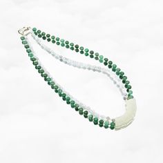 Elevate your style with the Auspicious Double Layer Green Jade Necklace, featuring antique-style mint jade Huang (璜). Revered as the emperor of gemstones, jade symbolizes virtues like grace, loyalty, and sincerity. This 16-inch necklace includes jadeite, moonstone, freshwater pearl, and a white jade Huang pendant.⚜ Auspicious Double Layer Green Jade Necklace❀ Mint Jadeite 2-4mm & Faceted Moonstone 2-3mm ❀ Green Jadeite 6mm & Fresh Water Pearl 2mm❀ Mint Jade Huang 0.5" x 1.75" (12m x 45m) ❀ Lengt Jade Gemstone Crystal Necklace With Round Beads, Jade Crystal Necklace With Round Beads, Jade Gemstone Crystal Necklaces With Round Beads, Elegant Green Jade Crystal Necklace, Jade Crystal Necklace With Round Gemstone Beads, Traditional Jade Necklace With Gemstone Beads, Traditional Jade Necklace For Meditation, Traditional Jade Necklaces For Meditation, Jade Gemstone Beads Jewelry For Meditation