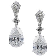 An absolutely gorgeous statement piece, these earrings are perfect for black tie wedding or elegant gala. This incredible pair of diamond drop earrings feature a matched pair of spectacular GIA certified E color, VS2 clarity pear shape diamonds, weighing 5.01 and 5.05 carats respectively. These pear shapes are suspended from two Asscher-cut and kite-shaped diamonds. The Asscher cut diamonds weigh 0.45 carat total, and the kites total 0.92 carats. The earrings are crafted in 18K white gold with d Vintage Drop Earrings, Engagement Earrings, Platinum Earrings, Asscher Cut Diamond, Expensive Jewelry, Fine Jewelry Designers, Pear Diamond, Diamond Drops, Pear Shaped Diamond