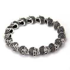 Finally, here is a sophisticated and stunning bracelet for women this Halloween season. This bracelet from Innovato Design is hand-hammered from high class 100% genuine sterling silver that showcases a design of connected three-dimensional skull beads. The beads have a micro pave setting of black cubic zirconia stones that dazzle with your movement. It is an intricate stranded type bracelet and will be the bestseller item to match your spooky costume this Halloween.    Product highlights: Black Sterling Silver Skull Jewelry, Black Skull Sterling Silver Jewelry, Silver Gothic Bracelets For Halloween, Gothic Silver Bracelets For Halloween, Silver Gothic Skull Bracelets, Black Metal Bracelet With Silver Beads, Silver Round Beads Jewelry For Halloween, Silver Jewelry With Round Beads For Halloween, Halloween Silver Jewelry With Round Beads