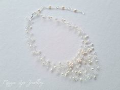 A truly beautiful bridal necklace, handmade with quality ivory freshwater pearls and the finest quality crystals set on a silver plated wire showing intricate detailing. The length is around 40cm with an extension chain to lengthen if you please. The drop on the necklace at its widest point is around 5.5-6 cm. All of our items are made to order so adjustments can be made with regards to materials and designs. Please message us if you require different specifications.  The design is handmade feat Silver Pearl Wedding Jewelry, Wedding Pearl Drop Necklaces, Pearl Drop Necklaces For Wedding, Delicate Pearl Beaded Necklaces For Wedding, Delicate Pearl Beaded Necklace For Wedding, White Pearl Wedding Gift Jewelry, Delicate Beaded Pearl Necklace For Wedding, Delicate Beaded Necklaces For Wedding, Pearl White Beaded Necklaces With Pearl Drop For Wedding