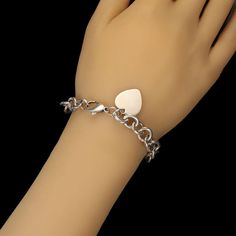 This is part of Chairish’s Costume Jewelry assortment.  Elegant Sterling Silver Link Bracelet with Heart – Perfect for Engraving  This sterling silver link bracelet with heart is a timeless piece that blends style with personalization. Crafted from high-quality sterling silver, this bracelet features open links with a charming heart charm, designed to be perfect for engraving a special message or initial. At 7.25 inches, it offers a versatile fit for most wrist sizes.  Weighing 29.4 grams, this White Gold Heart Charm Bracelet For Anniversary, White Gold Heart Bracelet With Charm For Anniversary, White Gold Metal Charm Bracelet For Anniversary, Classic Heart Shaped Sterling Silver Bracelet, Sterling Silver Heart-shaped Bracelet In White Gold For Anniversary, Anniversary Bracelets In Polished Stainless Steel, Polished Stainless Steel Anniversary Bracelets, Anniversary Stainless Steel Bracelet With Polished Finish, Classic Silver Heart Shaped Bracelets