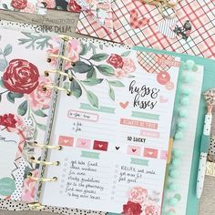 an open planner book with flowers and hearts on the pages, surrounded by other items