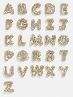 the letters and numbers are made out of gold - plated metal, with diamonds on them