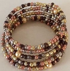 These are beautiful handmade  beaded bracelets which come in an assortment of widths.   Single strand to 8 strands.   Our single strand bracelets are great to wear with your other gold or silver bracelets to give them a touch of color to accent them. The price varies from $10.00 to $25.00. Please contact us for specific price or if you have any questions.  If you prefer a special color or style, we will take special orders. Gold Wrap Bracelet With Colorful Beads As Gift, Gold Wrap Bracelet With Colorful Beads, Multi-strand Beaded Bracelets With Spacer Beads As Gift, Bohemian Style Gold Stretch Bracelet With Round Beads, Gold Multi-strand Stackable Bracelets, Adjustable Multi-strand Beaded Bracelet With Gold Beads, Adjustable Multi-strand Gold Beaded Bracelets, Gold Multi-strand Spiritual Bracelet, Spiritual Gold Multi-strand Bracelets