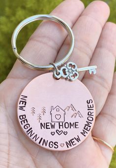 someone is holding their new home keychain in their hand