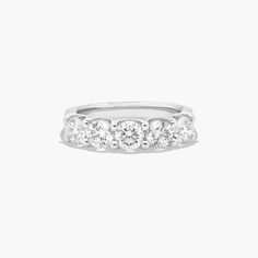 a white gold ring with five diamonds