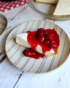 a piece of cheesecake with strawberry topping on a plate next to a slice of pie