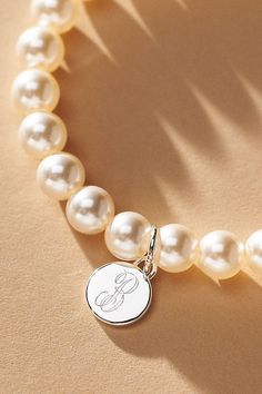 Elevate your special day with the exquisite Pearl Monogram Bracelet, a touch of personalization. Whether you opt for the initial of your cherished partner or choose to commemorate a beloved one, let this bracelet be a timeless symbol of connection and closeness. | Pearl Monogram Pearl Bracelet by Anthropologie in Alphabet, Women's, Gold/Plated Brass/Glass Mother Of The Bride Bracelet, Personalized Sterling Silver Initials Bracelet, Sterling Silver Initials Bracelet For Personalized Gift, Classic Personalized Charm Bracelet For Anniversary, Classic Personalized Bracelet, Personalized Initials Bracelet Jewelry, Elegant Personalized Charm Bracelet, Elegant Personalized Name Bracelet As Gift, Classic Sterling Silver Name Bracelet As Gift