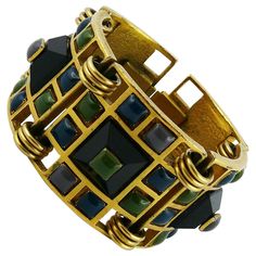 JEAN PAUL GAULTIER vintage rare articulated gold tone geometric cuff bracelet featuring multi colored enameled cabochons. Embossed JPG. Indicative measurements : length approx. 16.5 cm (6.50 inches) / inner circumference approx. 16.2 cm (6.38 inches) / width approx. 3.4 cm (1.34 inches). JEWELRY CONDITION CHART - New or never worn : item is in pristine condition with no noticeable imperfections - Excellent : item has been used and may have not more than two minor imperfections - Good : item has Yellow Gold Cuff Bracelet, Jean Paul Gaultier Vintage, Buy Earrings Online, Vintage Cuff Bracelet, Wide Cuff Bracelets, Buy Earrings, Gold Bracelet For Women, Cabochon Jewelry, Designer Fashion Jewelry