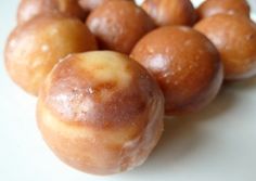 some donuts are sitting on a white surface