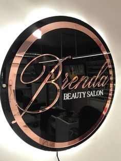 a round mirror with the words bridal beauty salon on it's front window