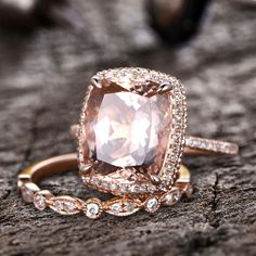 an engagement ring with a large pink diamond surrounded by smaller diamonds on top of it