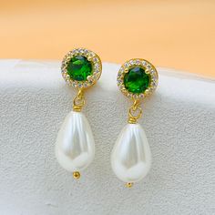 ✨ A unique gift for your loved ones with these elegant earrings, handcrafted from stunning emeralds and teardrop pearls.  ✨ A wonderful jewel that will attract attention on your special occasions. The Emerald pearl earring features a round emerald at the top,  elegantly paired with a shiny teardrop pearl at the bottom, creating a unique and elegant design. ✨ These 2.5cm long earrings are the perfect statement piece for any occasion. ✨ Whether for your mother, grandmother or sister, these earring Elegant Green Pearl Earrings Gift, Green Pearl Drop Jewelry, Green Drop Pearl Earrings For Wedding, Green Pearl Earrings For Wedding, Classic Green Pearl Drop Jewelry, Elegant May Birthstone Dangle Teardrop Earrings, Green Dangle Pearl Earrings For Anniversary, Green Pearl Drop Earrings For Anniversary, Green Teardrop Pearl Earrings For Wedding