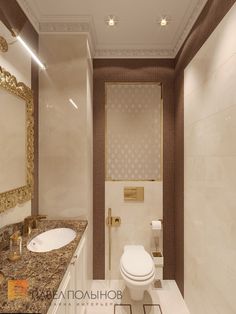 a bathroom with marble counter tops and gold trimmings on the walls, along with a white toilet