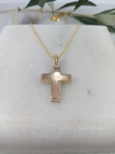 "A fine cross in K14 made of yellow solid gold. It's a simple cross that is decorated with small zircons creating four right angles (on the top, on the bottom on the right and left side of the cross). A simple, minimal, inter temporal cross. Ideal for a present, engagement gift, anniversary and baptism. It is one of the most beautiful designs and can easily be worn by a woman of any age, who likes minimal design. The dimensions of the cross are: Height 1,26 inches (3,2 cm.) Width 0,71 inches (1, Cross Christian, Simple Cross, Gold Cross Pendant, Christian Cross, Stone Gold, Sterling Silver Bangles, Gold Cross, 22k Gold, Minimal Design