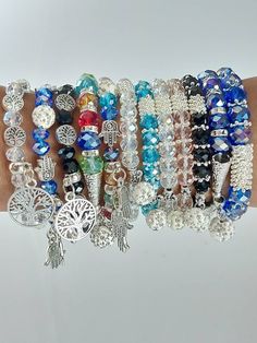 This are assorted charm bracelets made using  a stretching thread, beads and charms. The bracelets are marked with numbers for one to choose their preferred one in the next photo. The bracelets have a stretch thread hence can fit comfortable on any hand size. Shipping remains constant no matter the quantity of bracelets purchased.  Shipping is fast and only takes 3-7 days to ship worldwide Friendship Hand Wrapped Bangle Bracelet, Gift Crystal Bangle Bracelet With 8mm Beads, Handmade Silver Rosary Bracelet For Friendship, 8mm Beads Crystal Bangle Bracelet As Gift, Crystal Bangle Bracelet With 8mm Beads As Gift, Bohemian Crystal Bracelet With Faceted Beads As Gift, Round Charm Bracelet With Faceted Beads, Round Charm Bracelet With Faceted Beads For Gift, Hand Wrapped Silver Beaded Bracelet As Gift