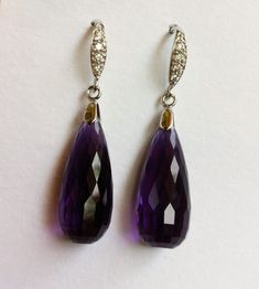 "Luxury Purple Amethyst sterling Silver Pave Earrings. Statement jewelry. Ultra violet stone dangles. February birthday. Artisan, Purple Amethyst Stone silver pave earrings. Vintage inspired, Pave sterling silver French earwires studded with tiny CZ in front that look like Diamonds. Elegant, sophisticated, and classy! These two lavish, faceted, AAAA+ quality, dark purple Amethyst briolettes are gems with vibrant purple hues, both stones are approximately 31 carats, each 22 x 10mm, the earrings a Purple Sterling Silver Teardrop Dangle Earrings, Purple Gemstone Accented Round Earrings, Purple Gemstone Accent Round Earrings, Elegant Amethyst Teardrop Dangle Earrings, Formal Amethyst Gemstone Earrings, Round Purple Earrings With Gemstone Accents, Amethyst Gemstone Earrings For Formal Occasions, Purple Round Earrings With Gemstone Accents, Formal Amethyst Drop Earrings