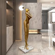 a gold statue is standing in the middle of a marble floored room with white walls